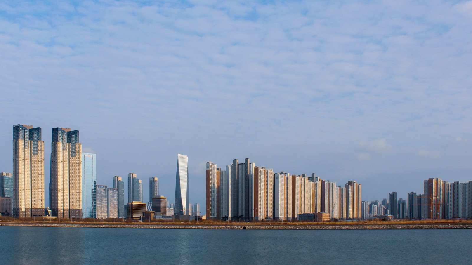 a large body of water with a city in the background